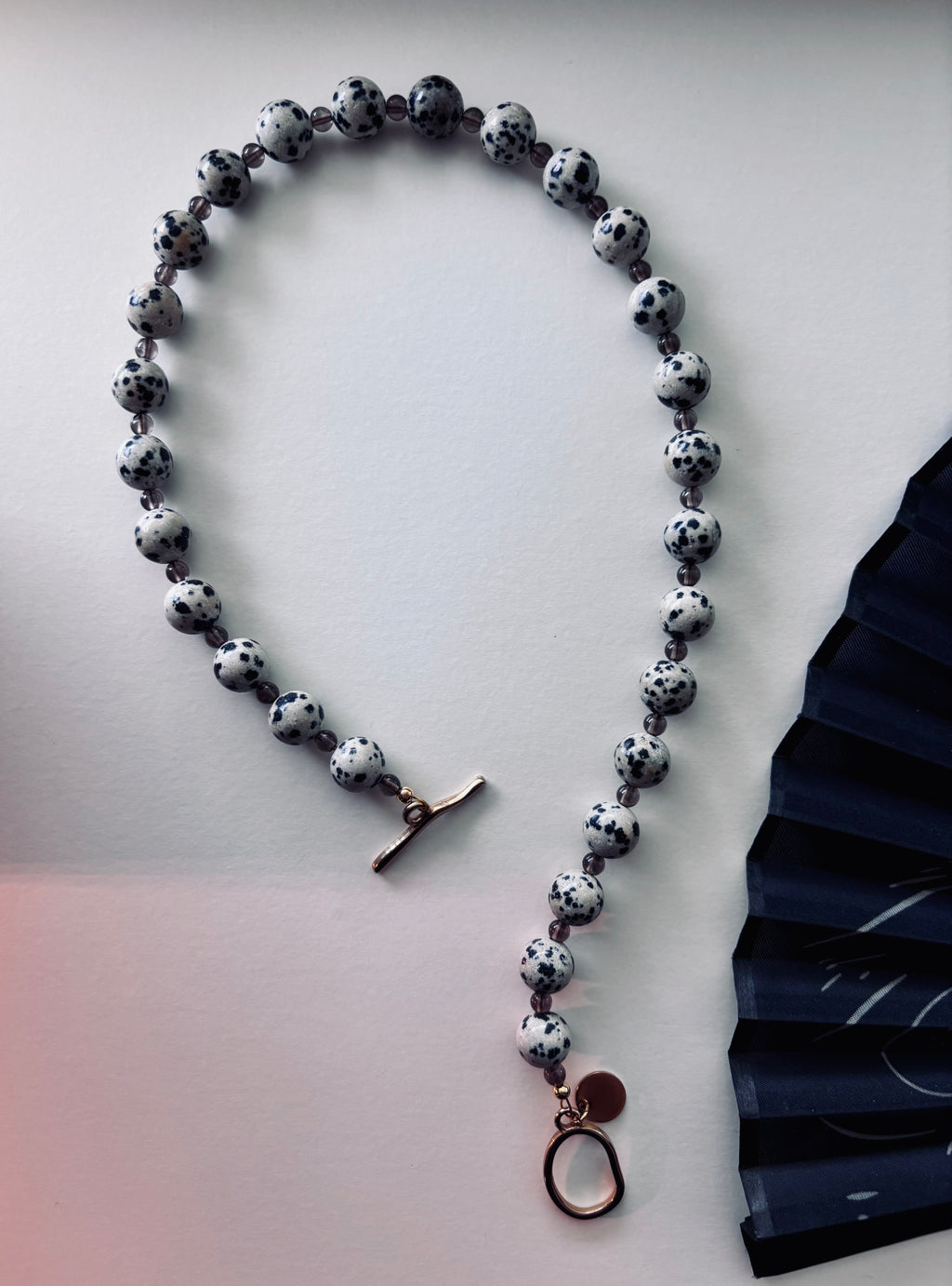 Statement necklace with Dalmatian Jasper and Smoky Quartz beads and gold toggle clasp