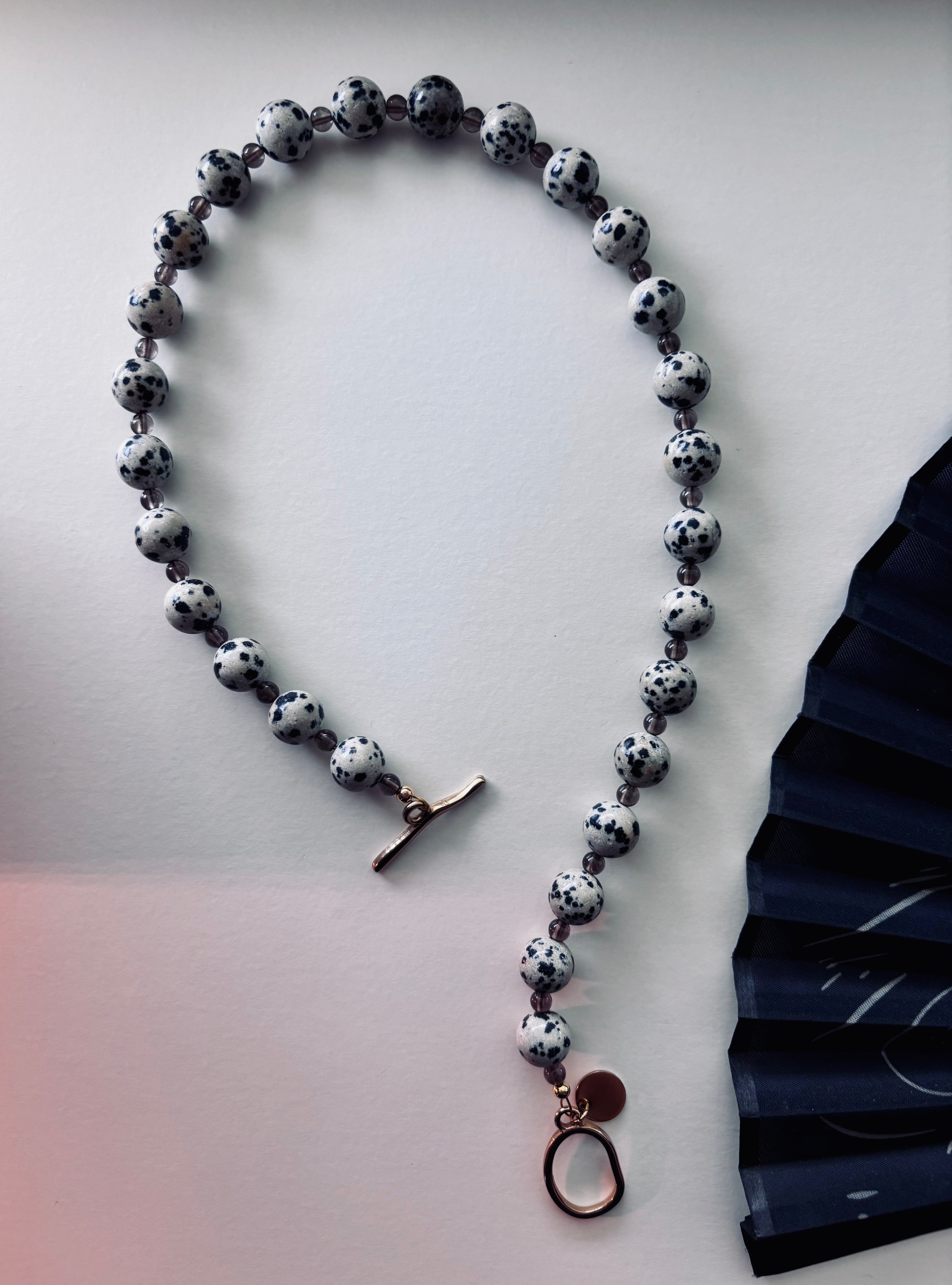 Statement necklace with Dalmatian Jasper and Smoky Quartz beads and gold toggle clasp